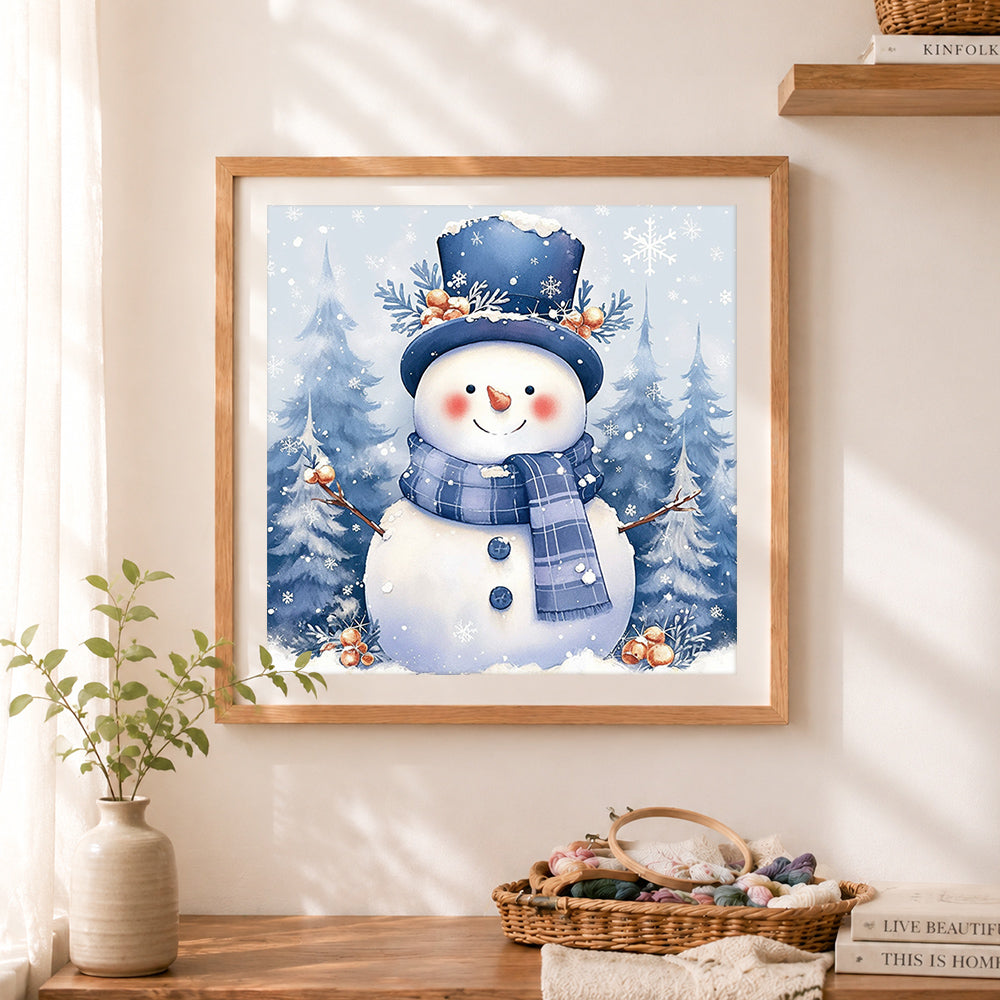 Finished blue top hat snowman and forest cross stitch artwork displayed as home decor