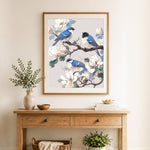 Finished bluebirds on magnolia branches cross stitch artwork displayed as home decor