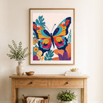 Finished bold artistic butterfly cross stitch artwork displayed as home decor