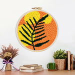 Finished bold black and yellow leaf artwork displayed on a wall