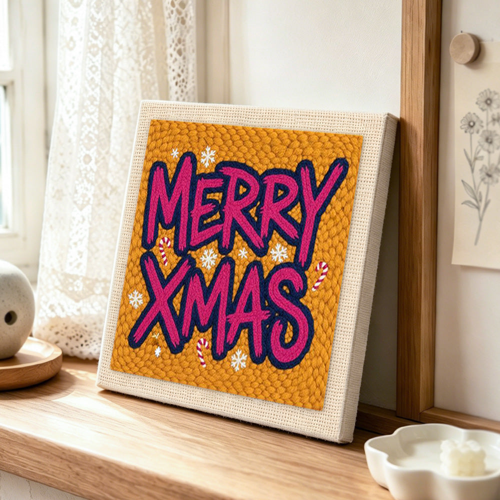 Bold merry xmas lettering punch needle artwork displayed on a table