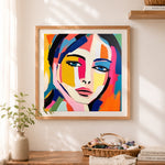 Finished bold pop art color block portrait cross stitch artwork displayed as home decor