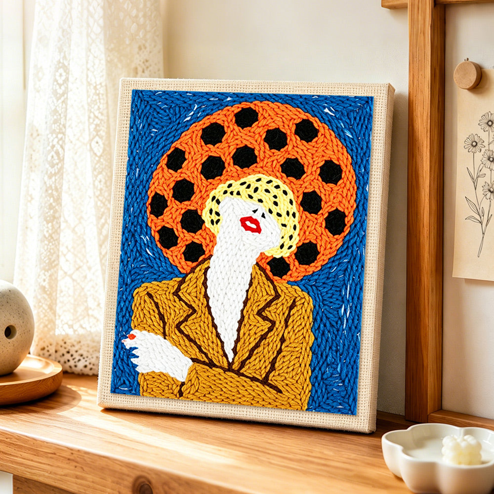 Bold pop art woman punch needle artwork displayed on a table