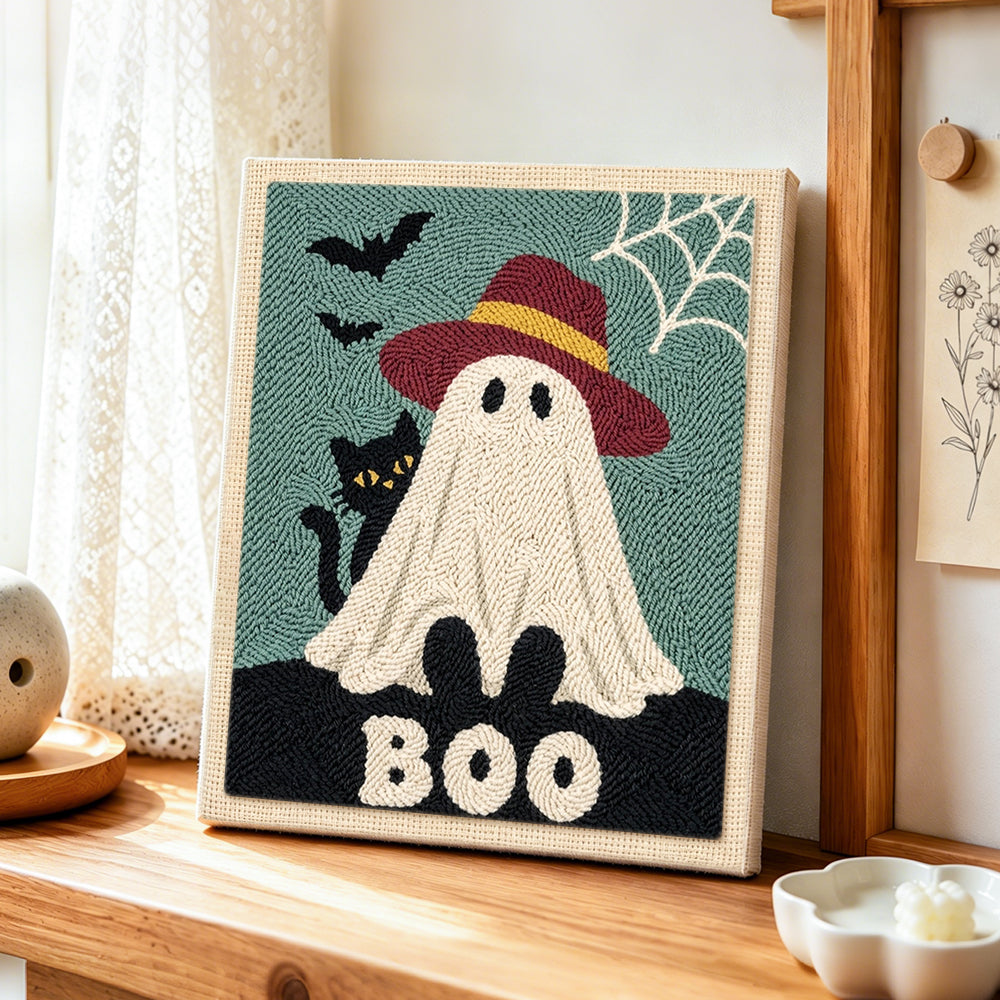 Boo ghost with hat punch needle artwork displayed on a table
