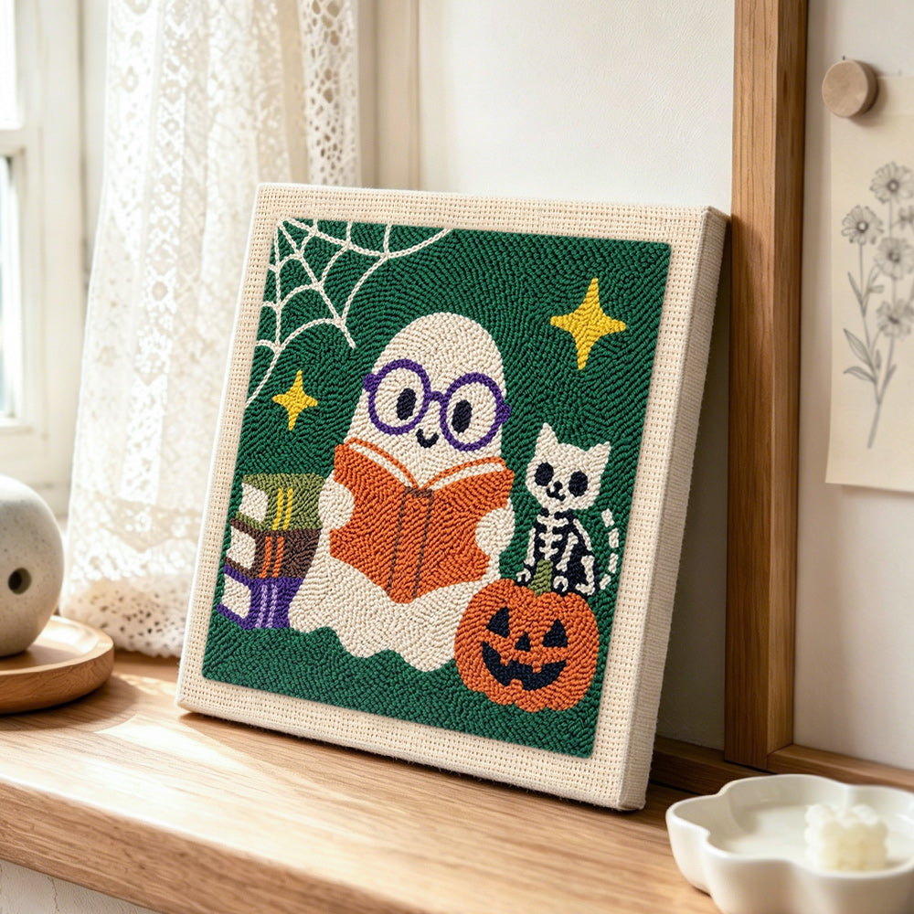 Book‑loving ghost punch needle artwork displayed on a table