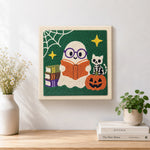 Finished book‑loving ghost artwork displayed on a wall