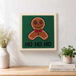 Finished bow tie gingerbread man art artwork displayed on a wall
