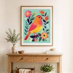 Finished bright bird and blooms cross stitch artwork displayed as home decor