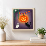 Finished bright glowing pumpkin artwork displayed on a wall