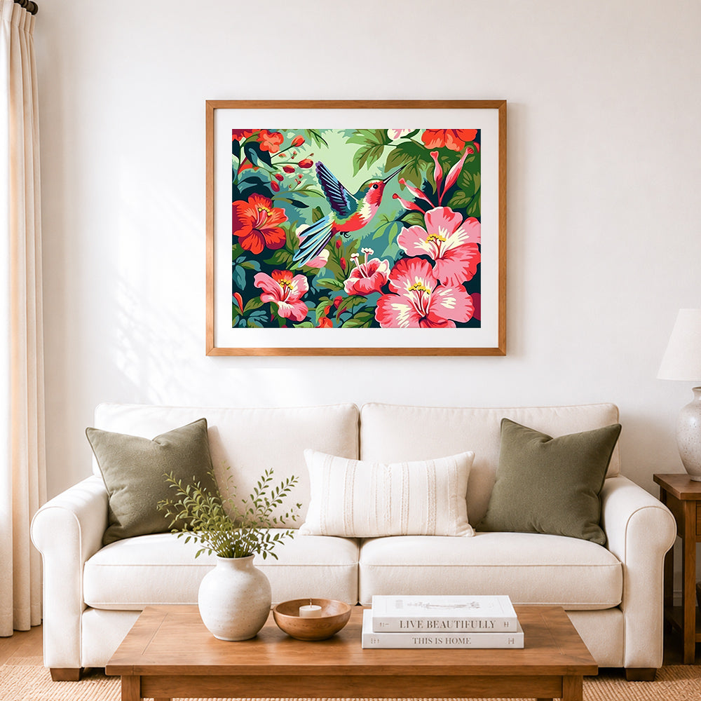 Finished bright hummingbird in floral garden cross stitch artwork displayed as home decor