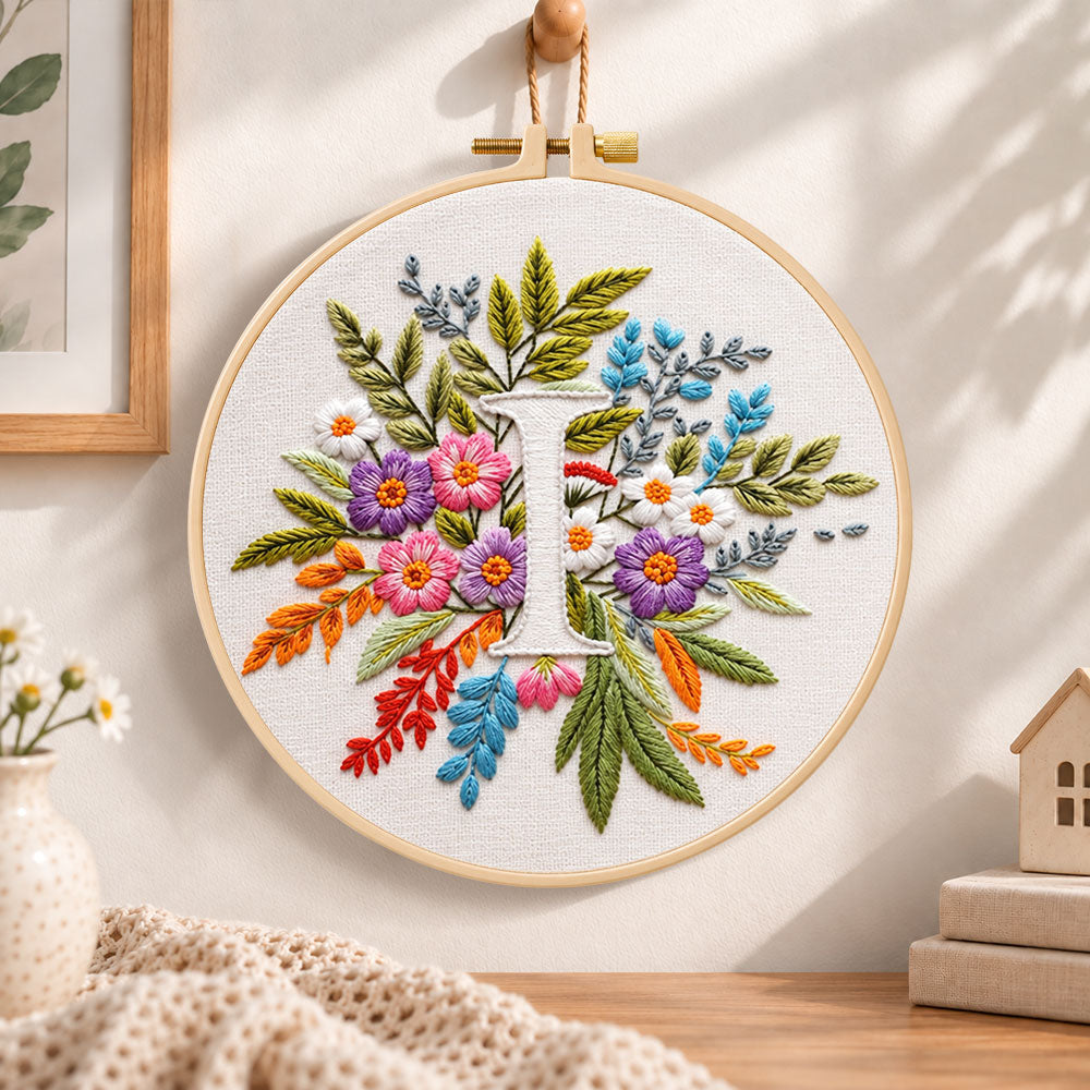 Bright mixed petals and letter i embroidery hoop wall art displayed as warm and cozy handmade home decor