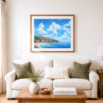 Finished bright summer coastal town cross stitch artwork displayed as home decor