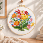 Bright wildflower cluster embroidery hoop wall art displayed as warm and cozy handmade home decor