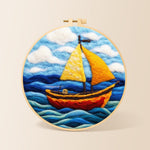Bright yellow sailboat on blue waves needle felting kit for beginners with a round wooden frame