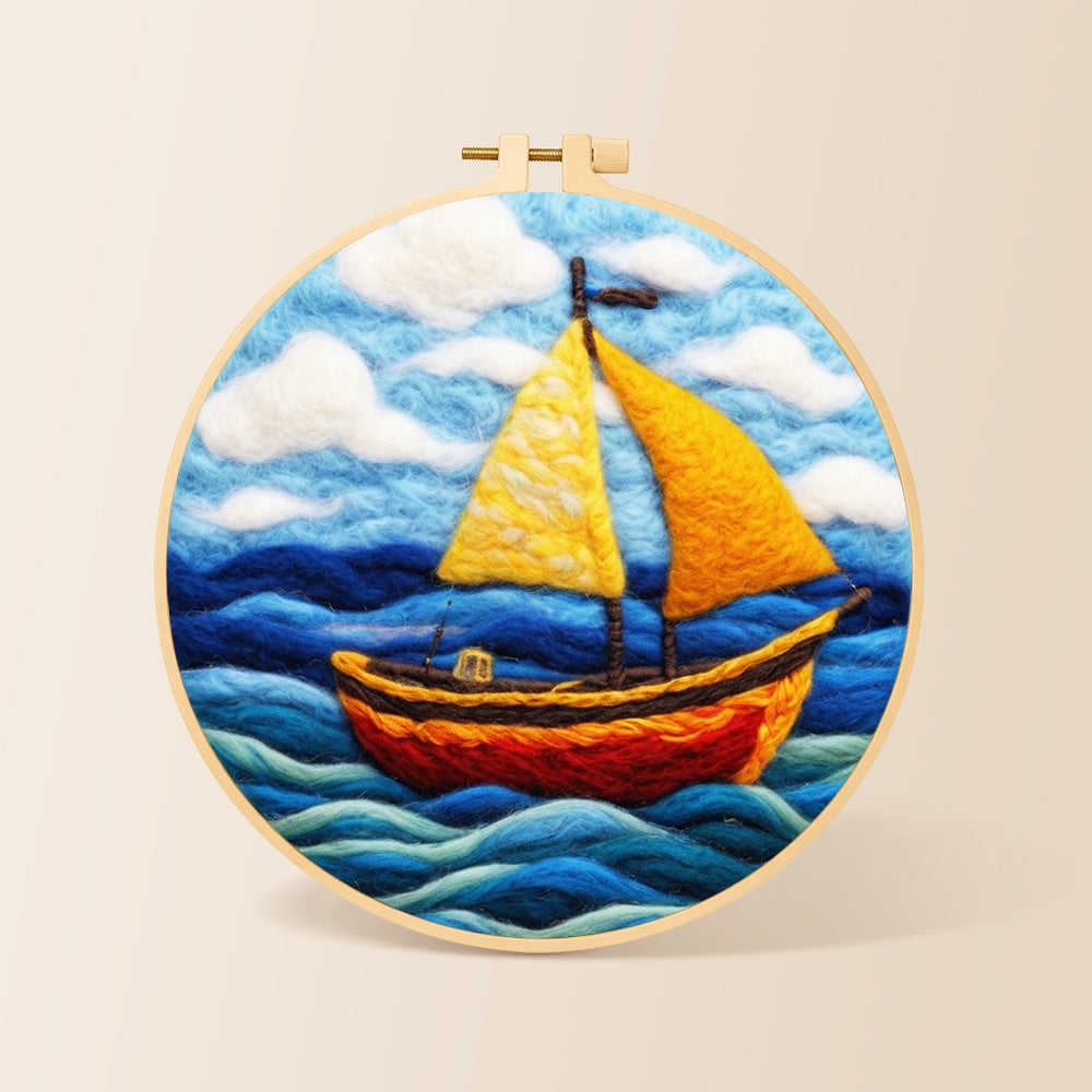 Bright yellow sailboat on blue waves needle felting kit for beginners with a round wooden frame