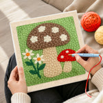 Creating handmade brown and red mushrooms punch needle artwork