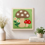 Finished brown and red mushrooms artwork displayed on a wall