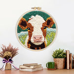 Finished brown and white cow face artwork displayed on a wall