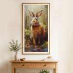 Finished brown rabbit sitting in shallow water cross stitch artwork displayed as home decor
