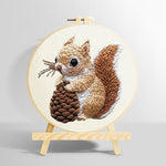 Brown squirrel holding pine cone punch needle kit for beginners