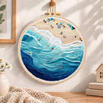 Bustling ocean surf embroidery hoop wall art displayed as warm and cozy handmade home decor