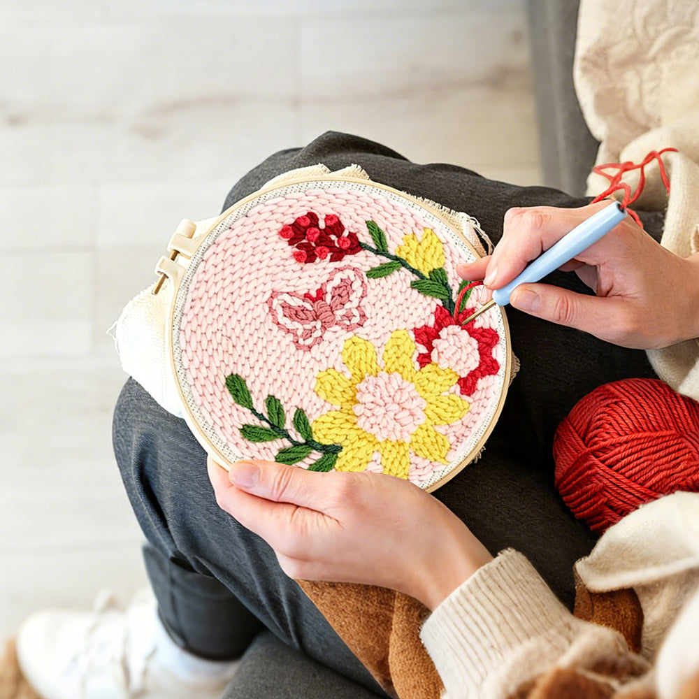 Creating handmade butterfly and blooming flowers punch needle artwork