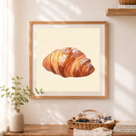 Finished buttery croissant with powdered sugar cross stitch artwork displayed as home decor
