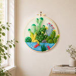 Cactus garden with fish needle felt wall art displayed in a bright home interior