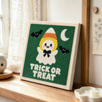 Candy corn ghost punch needle artwork displayed on a table