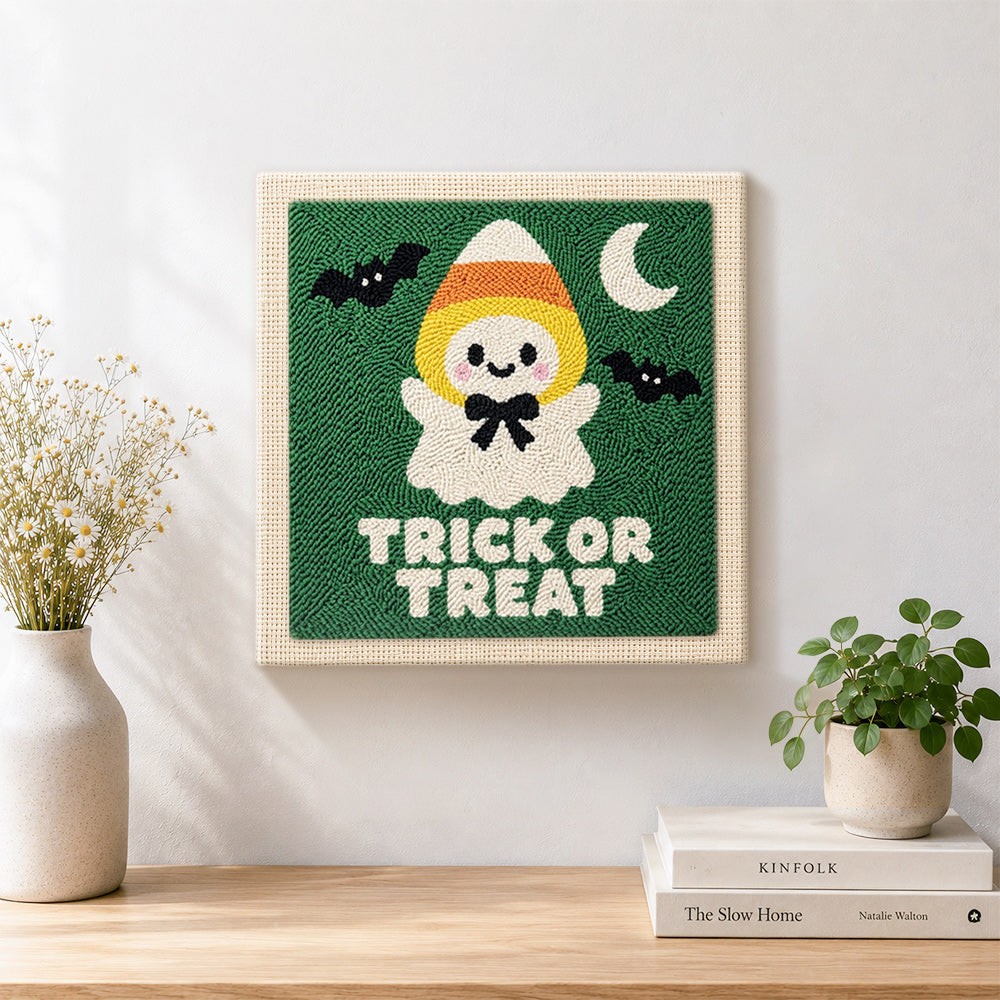 Finished candy corn ghost artwork displayed on a wall