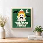 Finished candy corn ghost artwork displayed on a wall