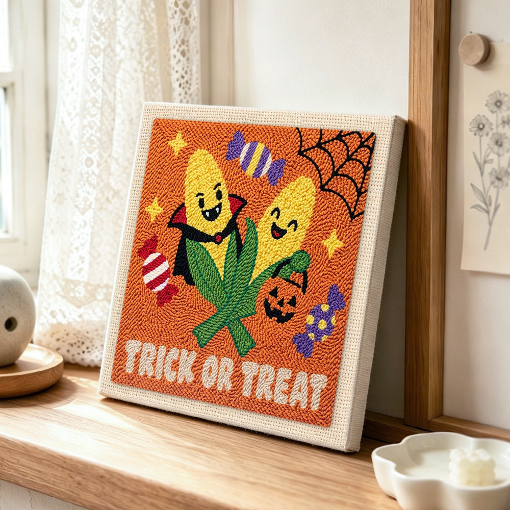 Candy corn halloween pair punch needle artwork displayed on a table