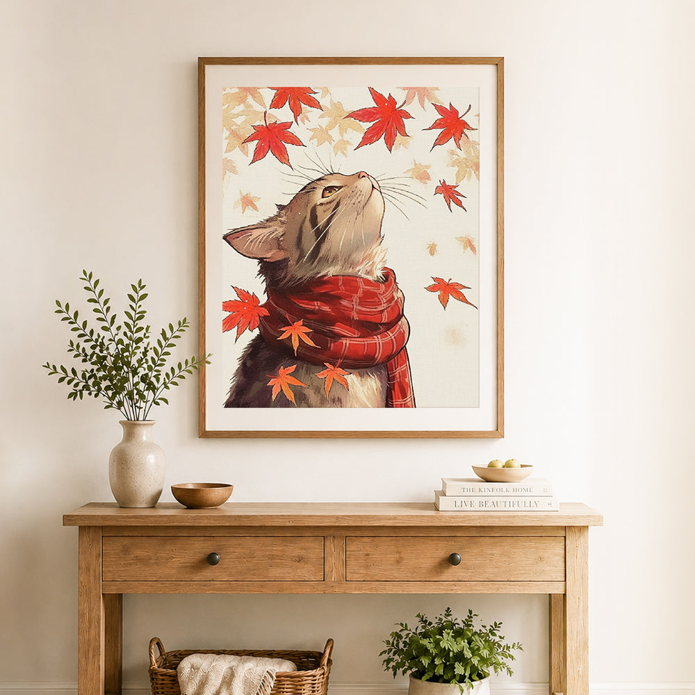 Finished cat admiring autumn maple cross stitch artwork displayed as home decor