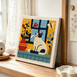 Cat and flower vase on windowsill punch needle artwork displayed on a table