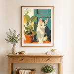 Finished cat beside potted plant cross stitch artwork displayed as home decor