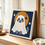 Cat in ghost costume punch needle artwork displayed on a table
