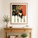 Finished cat resting on white fence cross stitch artwork displayed as home decor