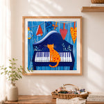 Finished cat sitting on piano cross stitch artwork displayed as home decor