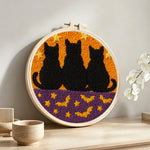 Cats and bats punch needle artwork displayed on a table