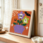 Cauldron spooky blooms punch needle artwork displayed on a table