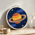 Celestial saturn punch needle artwork displayed on a table