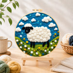 Finished charming black-faced sheep in sunny meadow needle felting displayed on a wooden easel