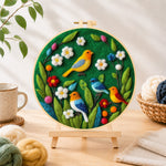 Finished charming flock of colorful birds needle felting displayed on a wooden easel