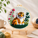 Finished charming little tiger needle felting displayed on a wooden easel