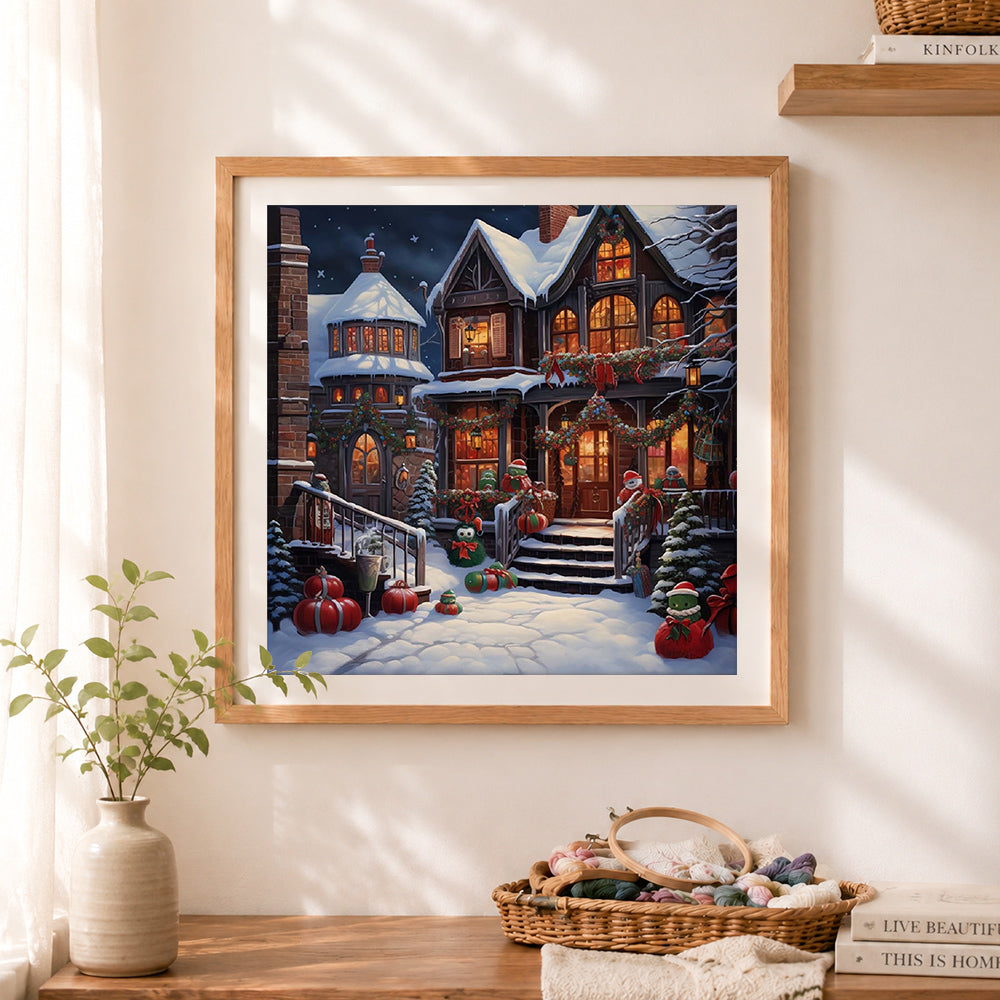 Finished charming winter cottage cross stitch artwork displayed as home decor