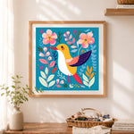 Finished cheerful golden hummingbird cross stitch artwork displayed as home decor