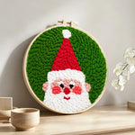 Cheerful santa portrait punch needle artwork displayed on a table