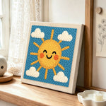 Cheerful smiley sun punch needle artwork displayed on a table
