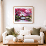 Finished cherry blossom arch bridge cross stitch artwork displayed as home decor