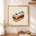 Finished cherry slice cake cross stitch artwork displayed as home decor